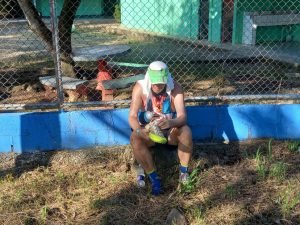 Man sitting outside after completing a stage of the Coastal Challenge.