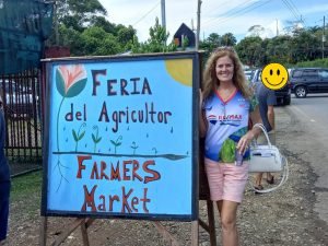 Woman in front of sign.