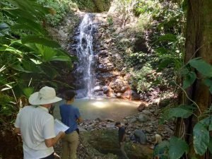 People near waterfall.